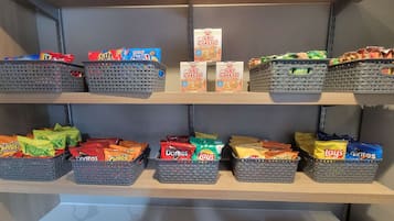 A snack display with various brands like Ritz, Mini Chips, Doritos, and Lay's.