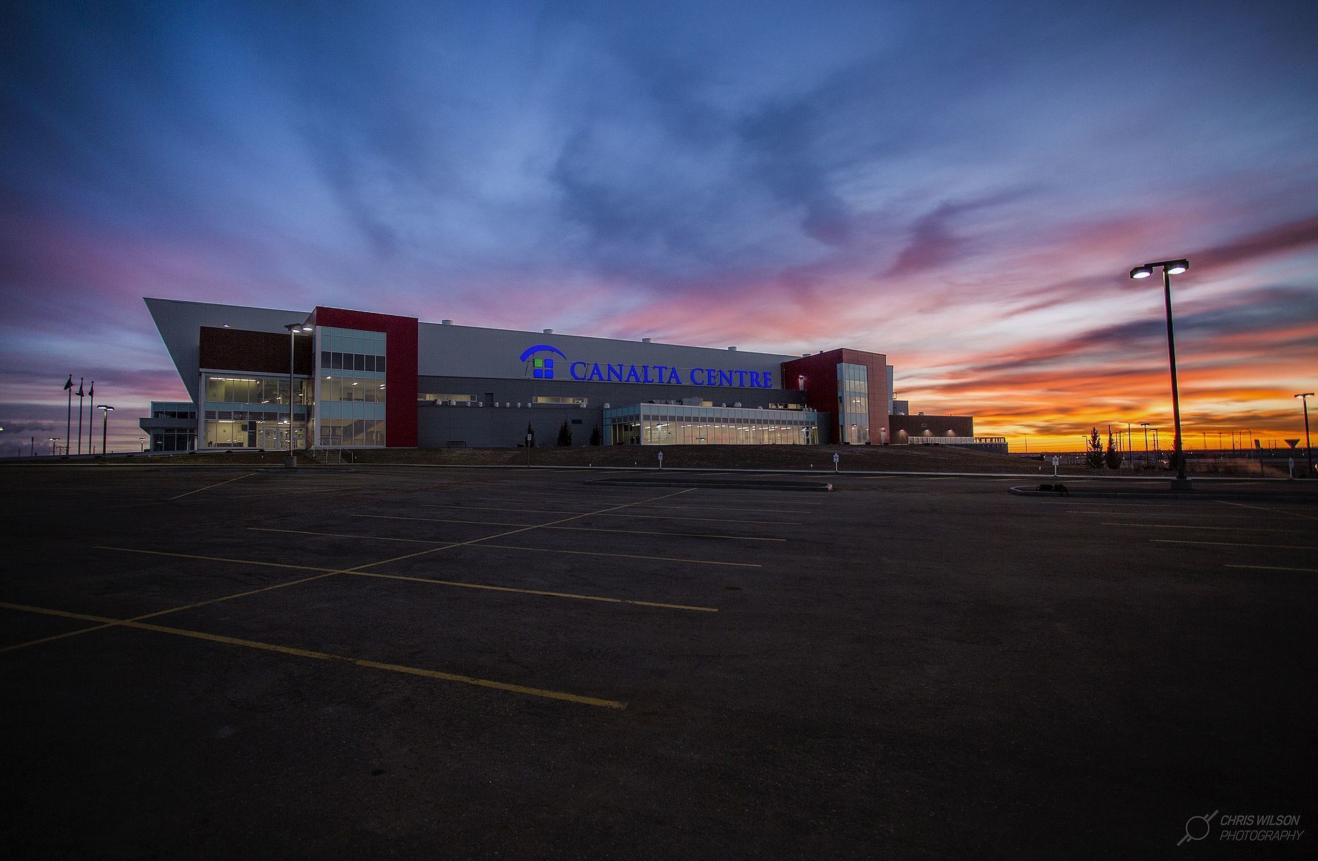A modern building with a prominent sign reading "CANALTA CENTRE" against a twilight sky.