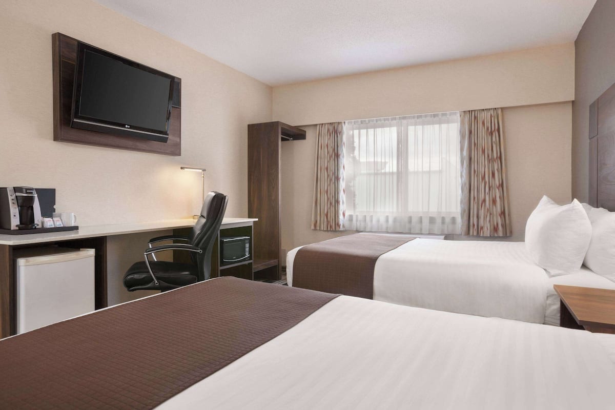 Room, 2 Queen Beds, Non Smoking | Pillowtop beds, individually decorated, desk, blackout drapes