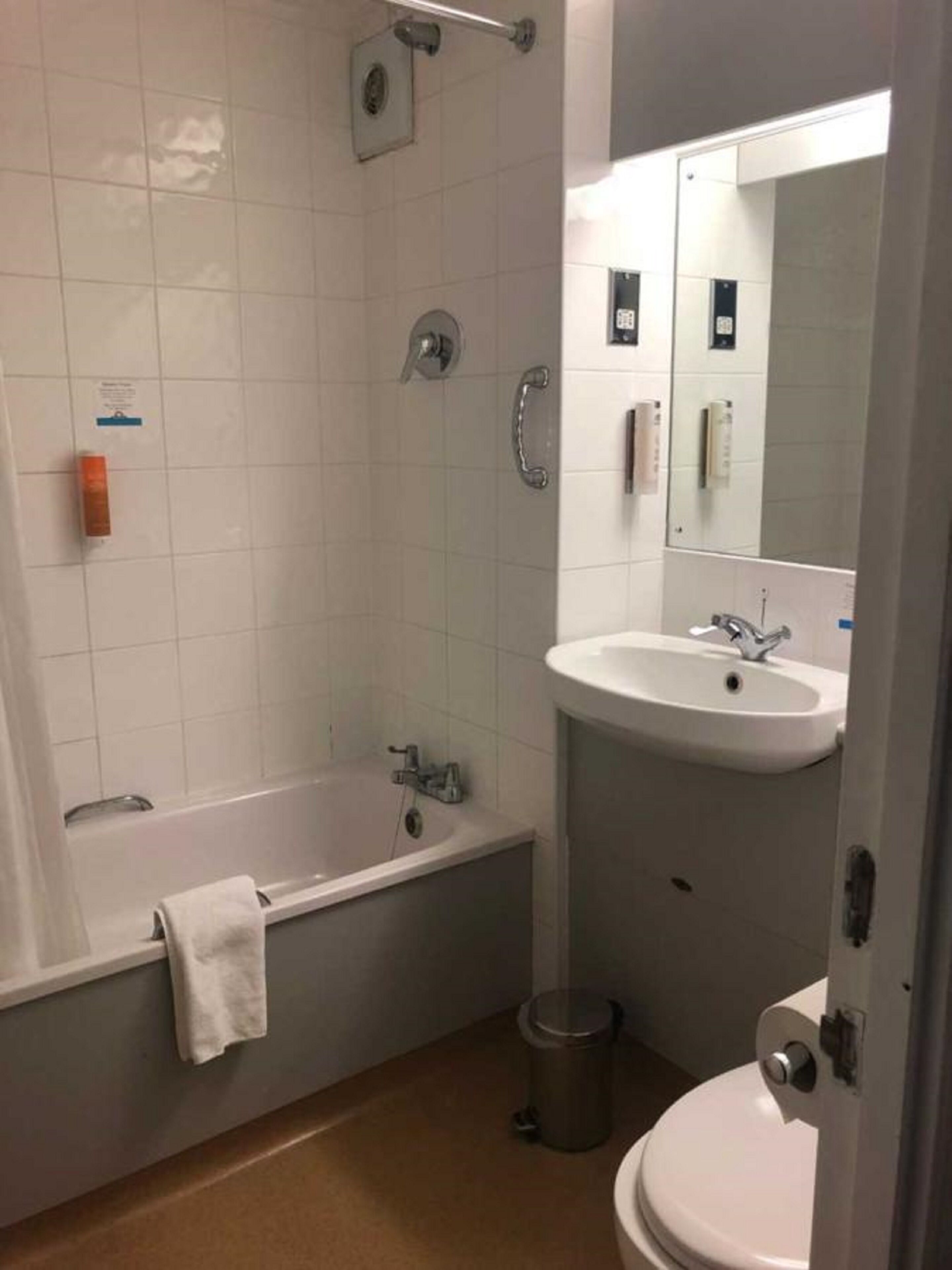 A bathroom with a bathtub, a sink, a toilet, and a shower.