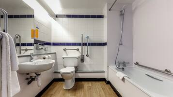 A modern bathroom with a sink, toilet, and shower.