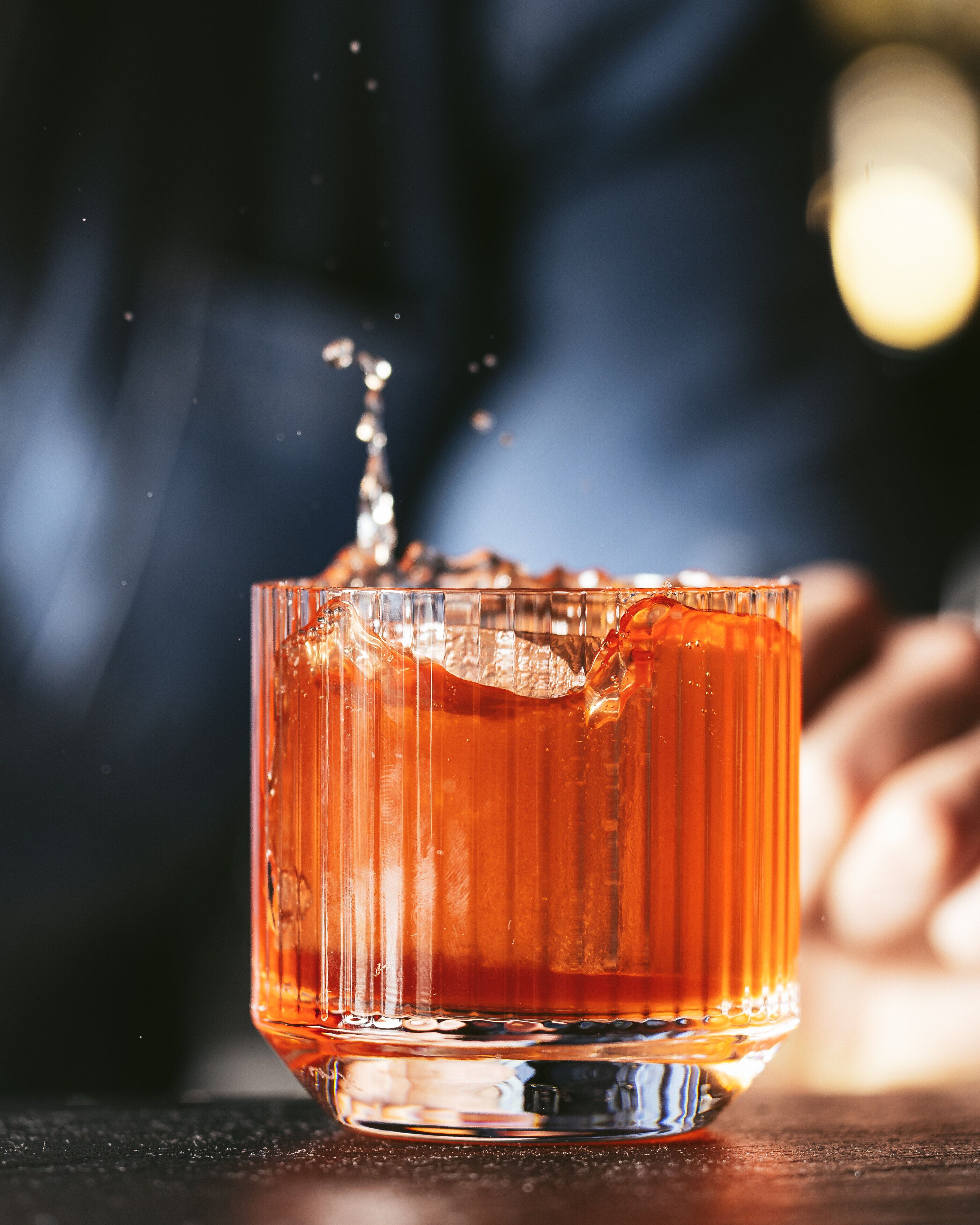 A close-up of a glass with a liquid, possibly a drink, with a blurred background.