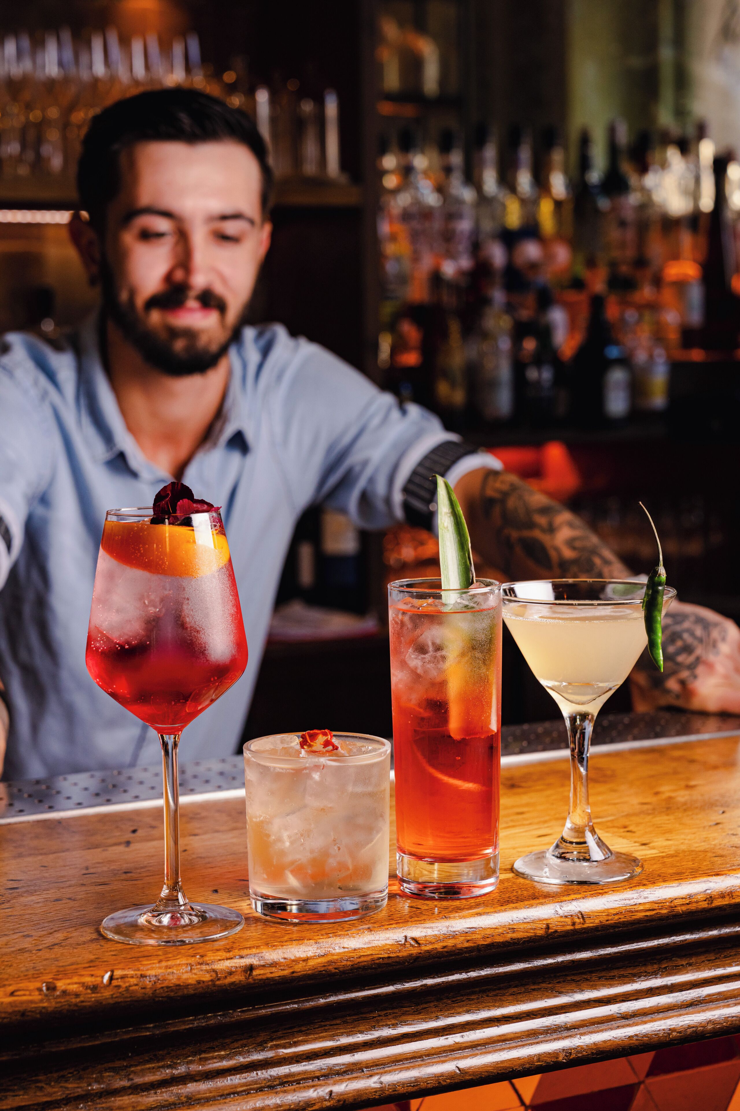 A bar with three different cocktails on the counter.