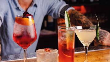 A bar with three different cocktails on the counter.