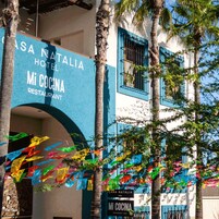 Un edificio con un letrero que indica 'Casa Natalia Hotel' y 'Mi Cocina Restaurant'.