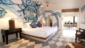 Een slaapkamer met een geruite vloer, een bed met witte beddengoed, twee lampen en een muurschildering.