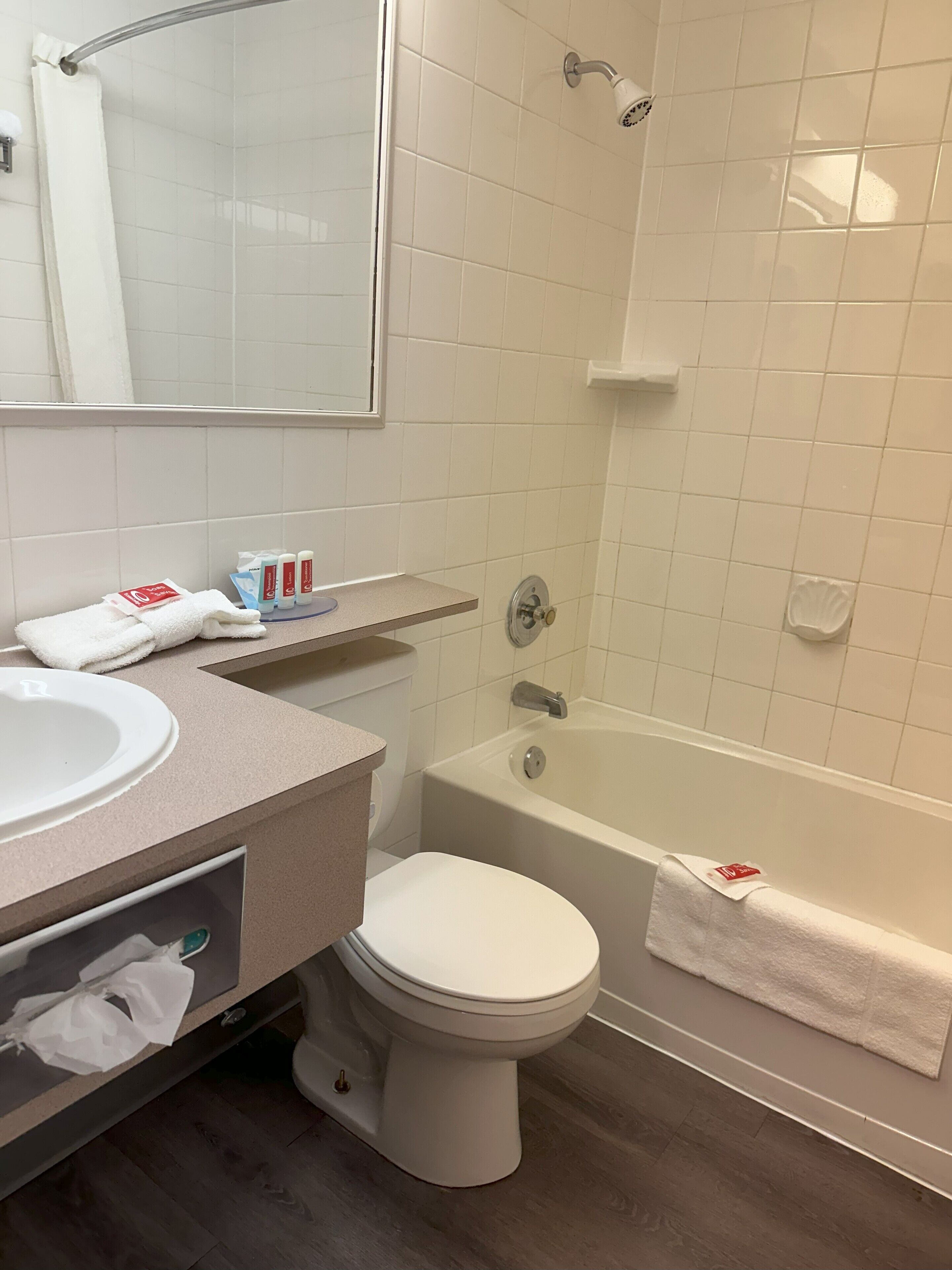 A bathroom with a sink, toilet, and bathtub.