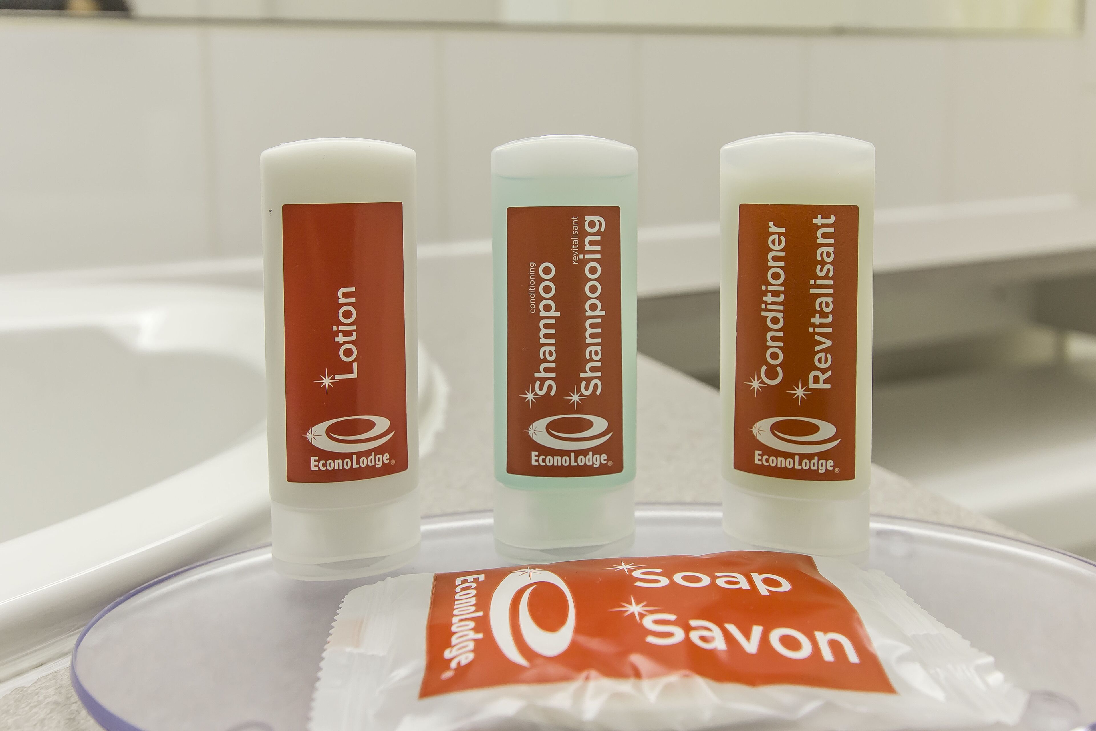 Three EconoLodge toiletries on a bathroom counter.