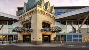 A building with a prominent Fairmont Vancouver Airport sign, large glass windows, and a modern architectural design.