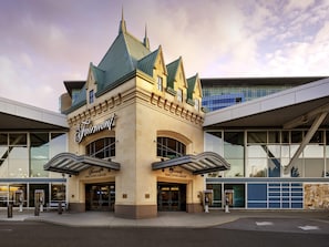 A building with a prominent Fairmont Vancouver Airport sign, large glass windows, and a modern architectural design. - Fairmont Vancouver Airport In-Terminal Hotel (Richmond)