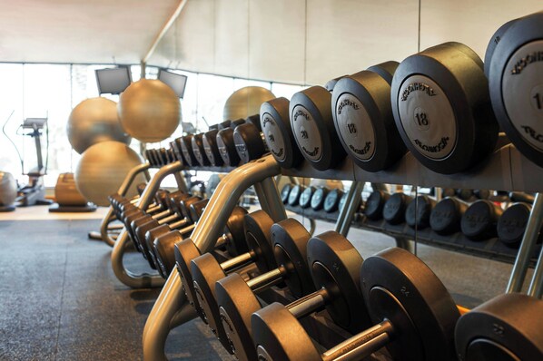 A row of weightlifting equipment in a gym, including dumbbells and barbells. - Le Méridien Mina Seyahi Beach Resort & Waterpark (Dubai)