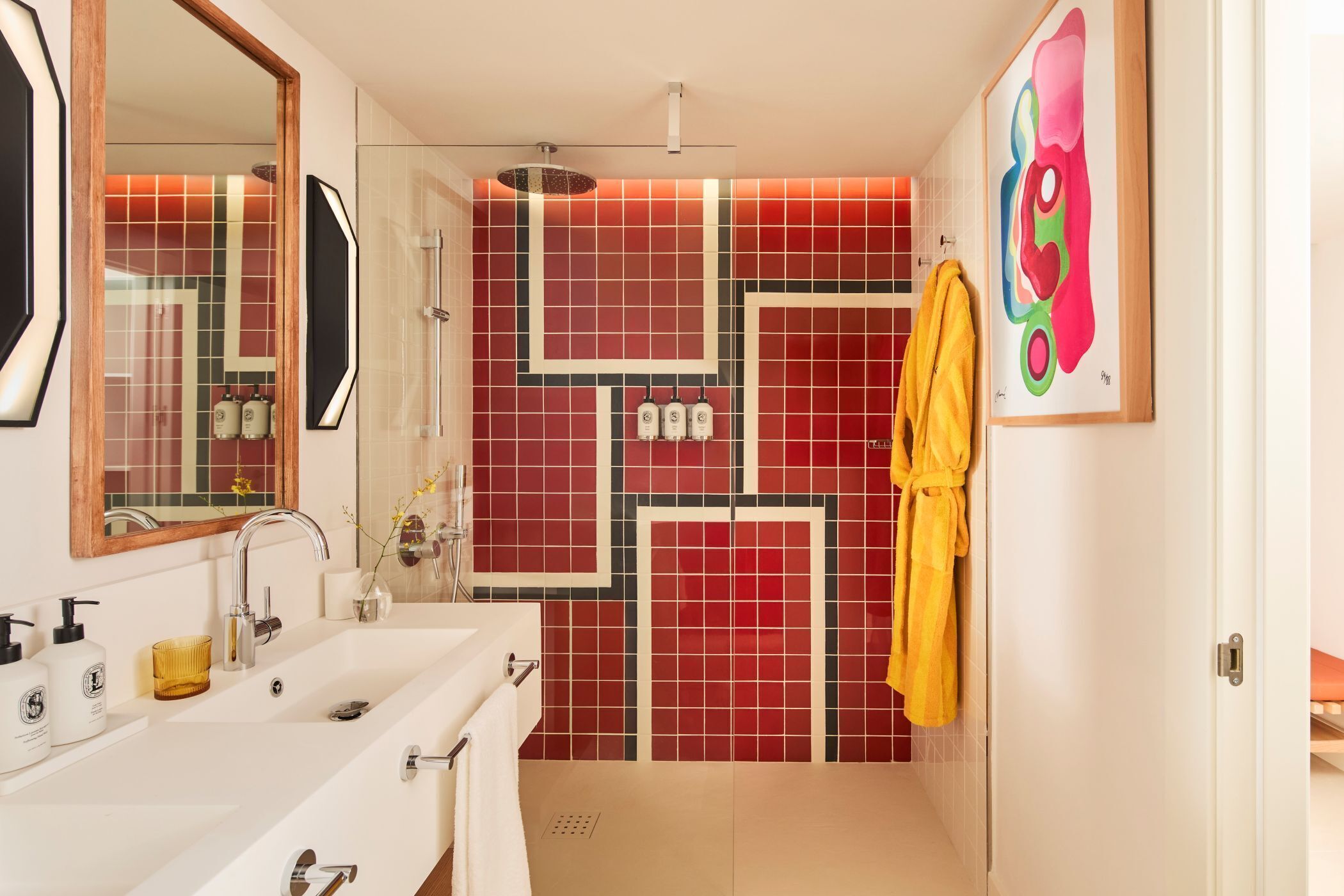 A bathroom with a white sink, mirror, and a shower area.