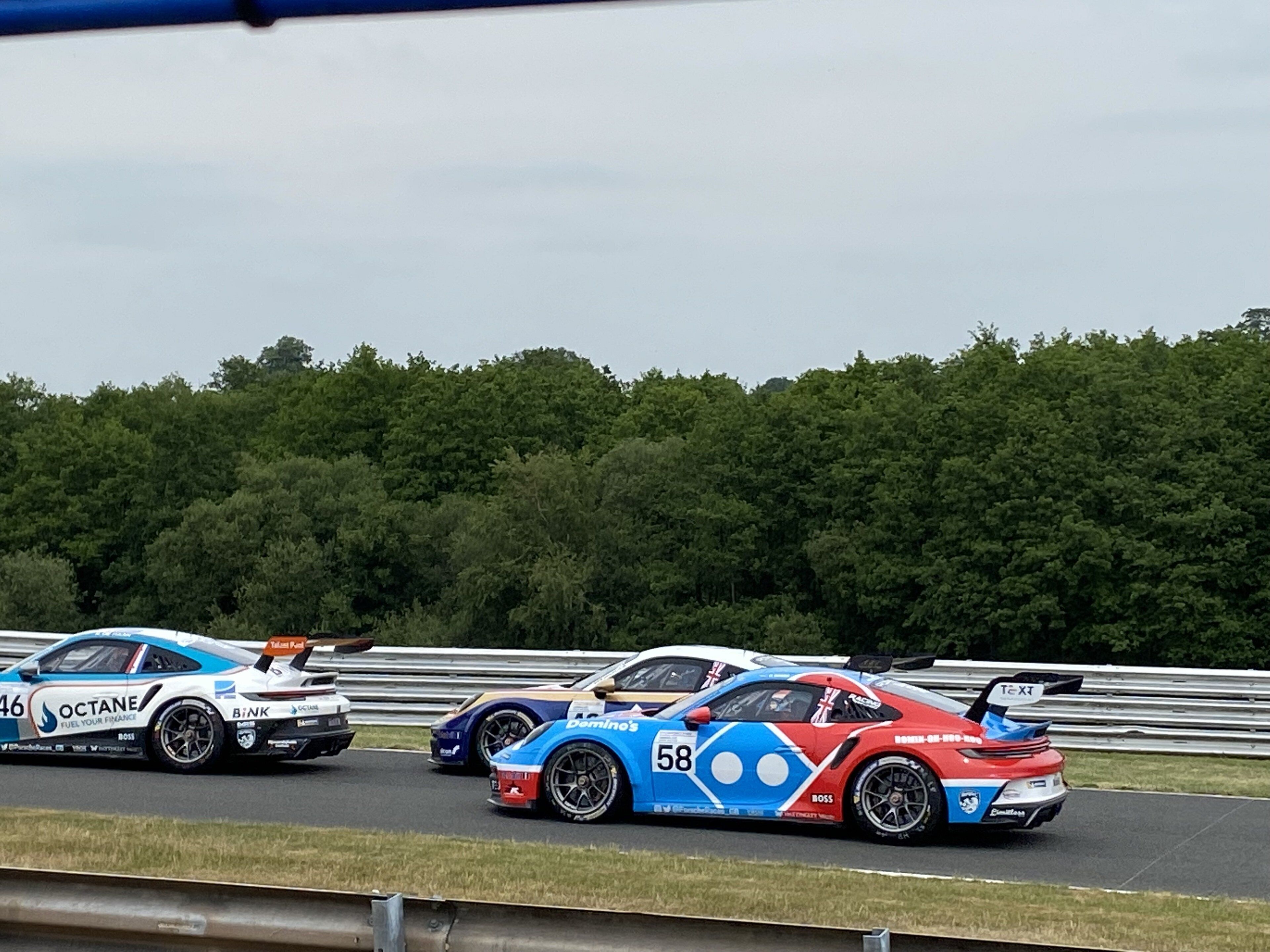 A race track with three race cars.