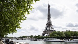La Torre Eiffel con barche ormeggiate lungo la Senna.