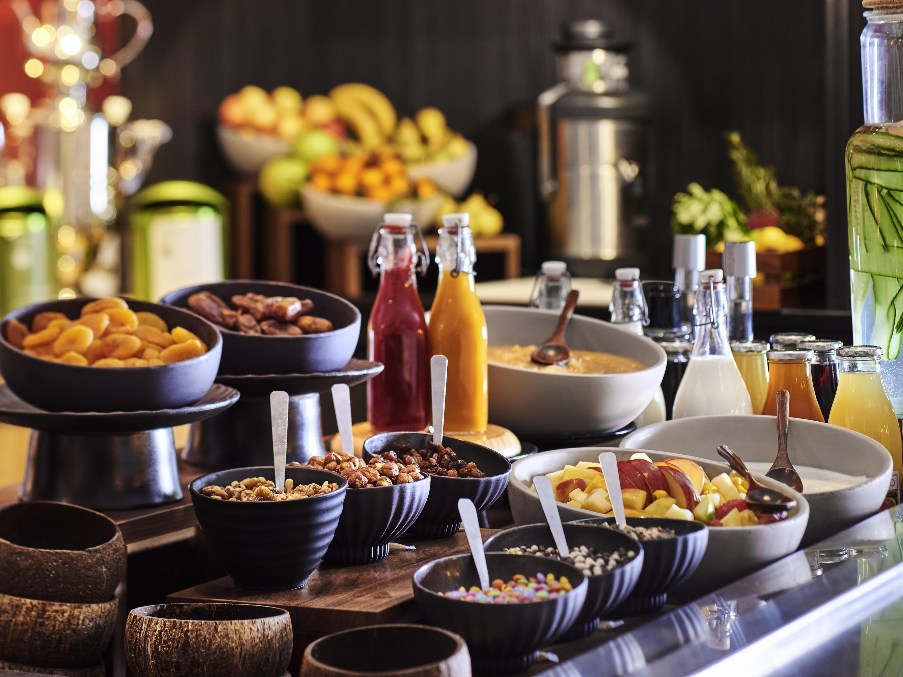 A buffet with various food items and beverages.