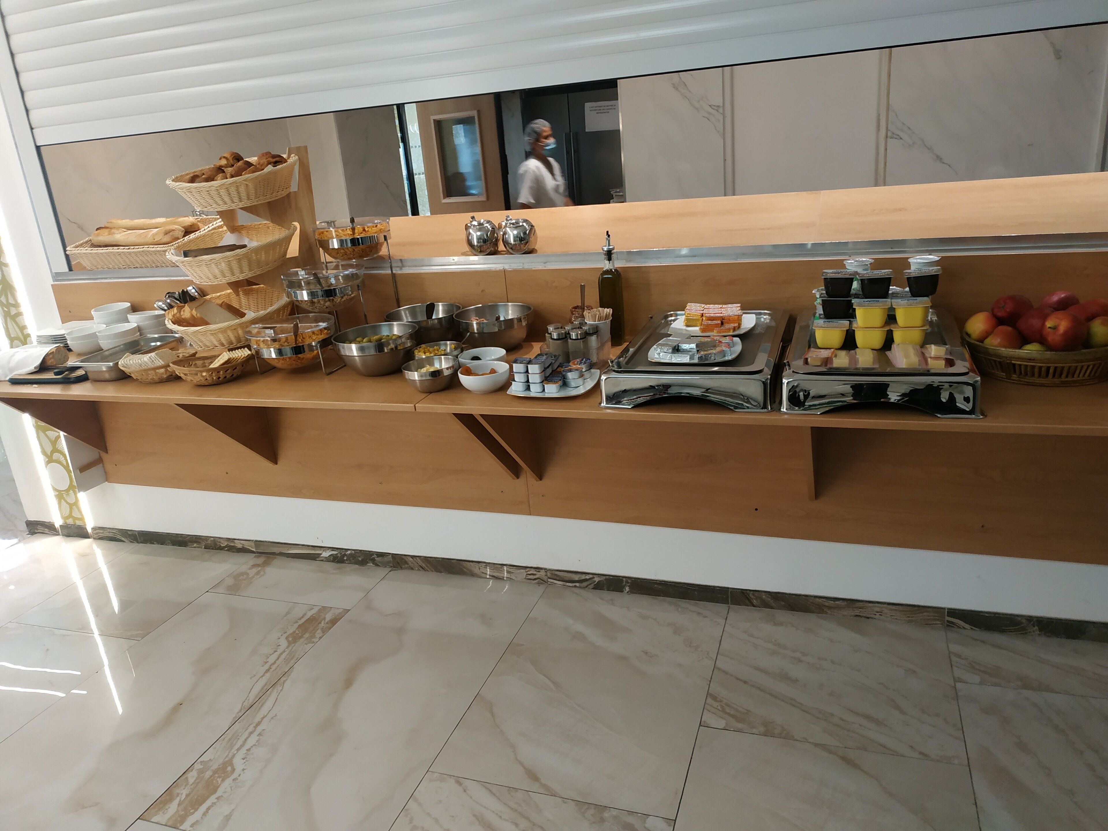 A buffet setup with various food items and utensils.