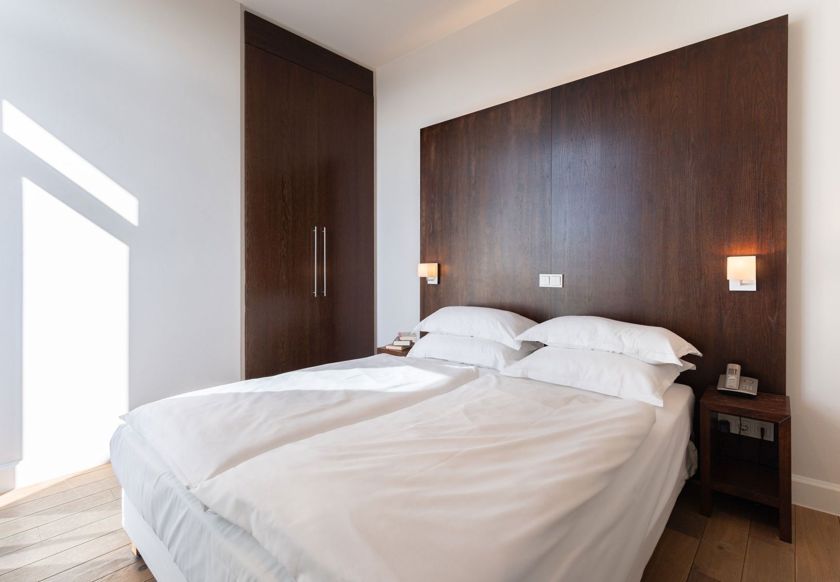 Hypo-allergenic bedding, desk, laptop workspace, blackout drapes