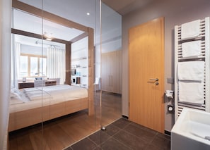 Relax in comfort with a spacious bed, desk, and spa-like bathtub.