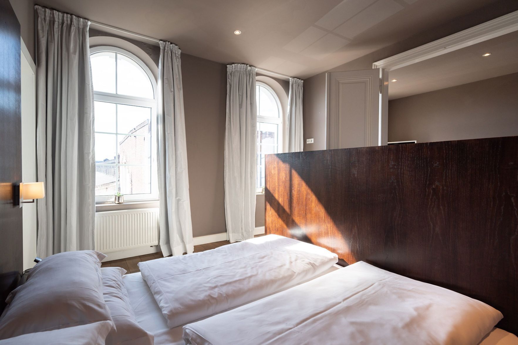 Hypo-allergenic bedding, desk, laptop workspace, blackout drapes