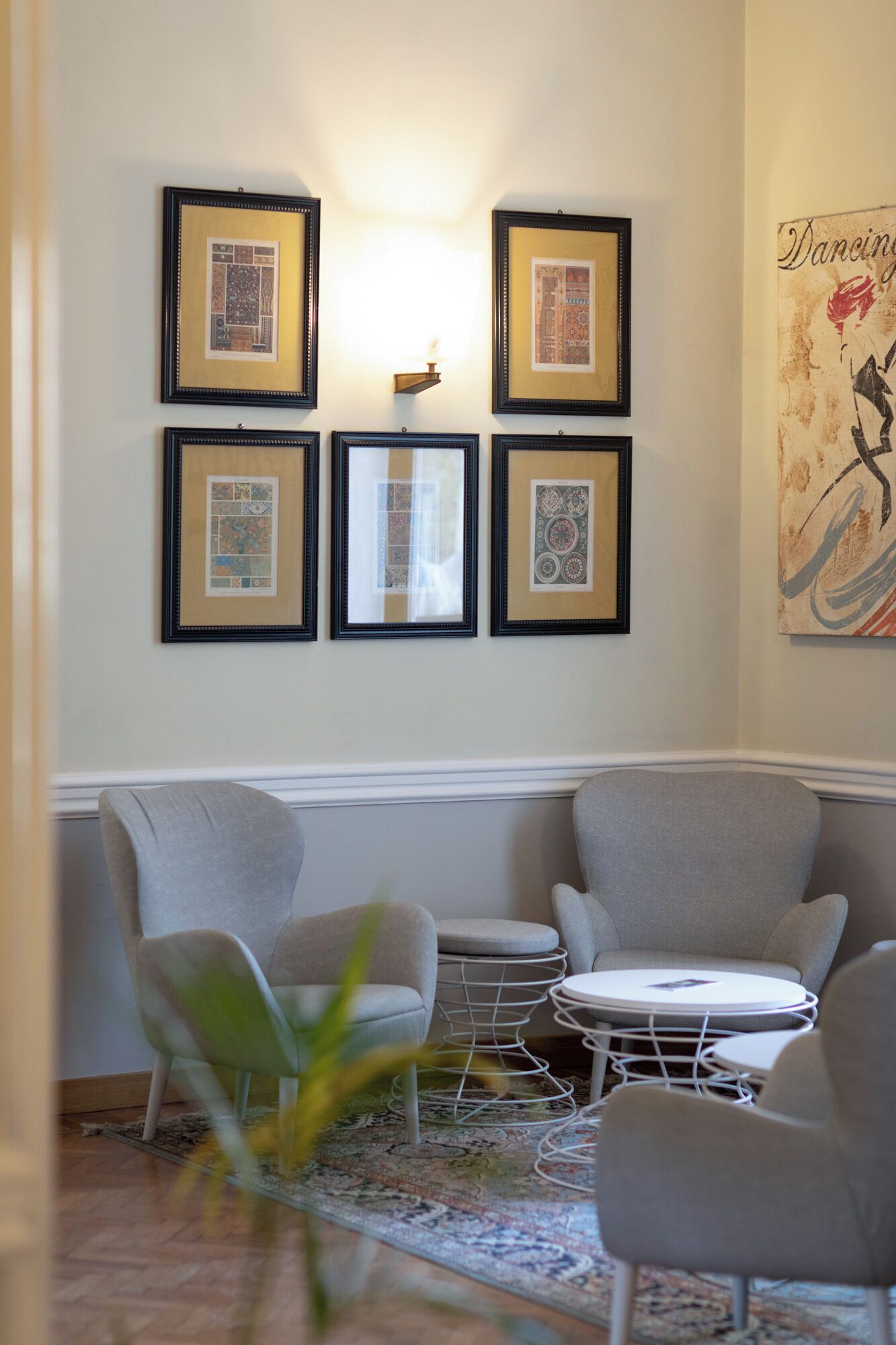 A modern living room with a sofa set, a coffee table, and framed artwork on the wall.