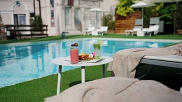 Seasonal outdoor pool, open 10:30 AM to 7:00 PM, pool umbrellas