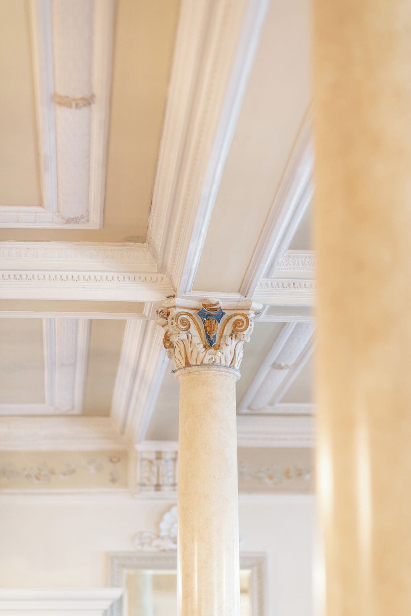 A classical architectural column with ornate capitals, part of a building's interior structure.