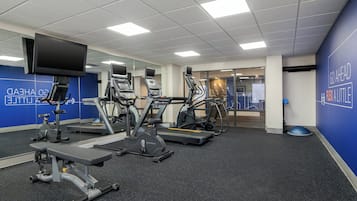 A fitness center with treadmills, elliptical machines, and a stationary bike.