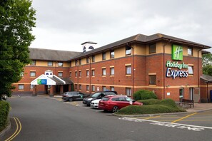 A Holiday Inn Express building with a parking lot in front.