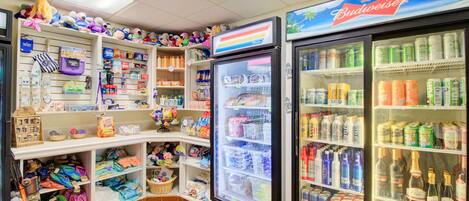 A convenience store with shelves stocked with snacks, drinks, and toys.