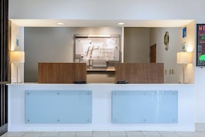 A reception desk with a sign for Holiday Inn Express & Suites.