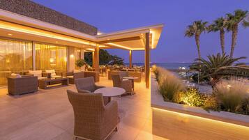 Relax in our ocean-view lounge with comfortable wicker furniture and a glass-enclosed space.