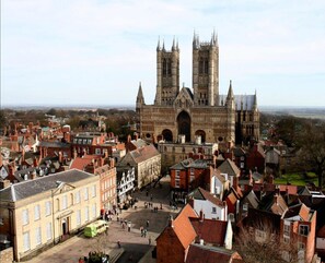 Stunning Gothic cathedral in a charming town square, surrounded by traditional buildings.