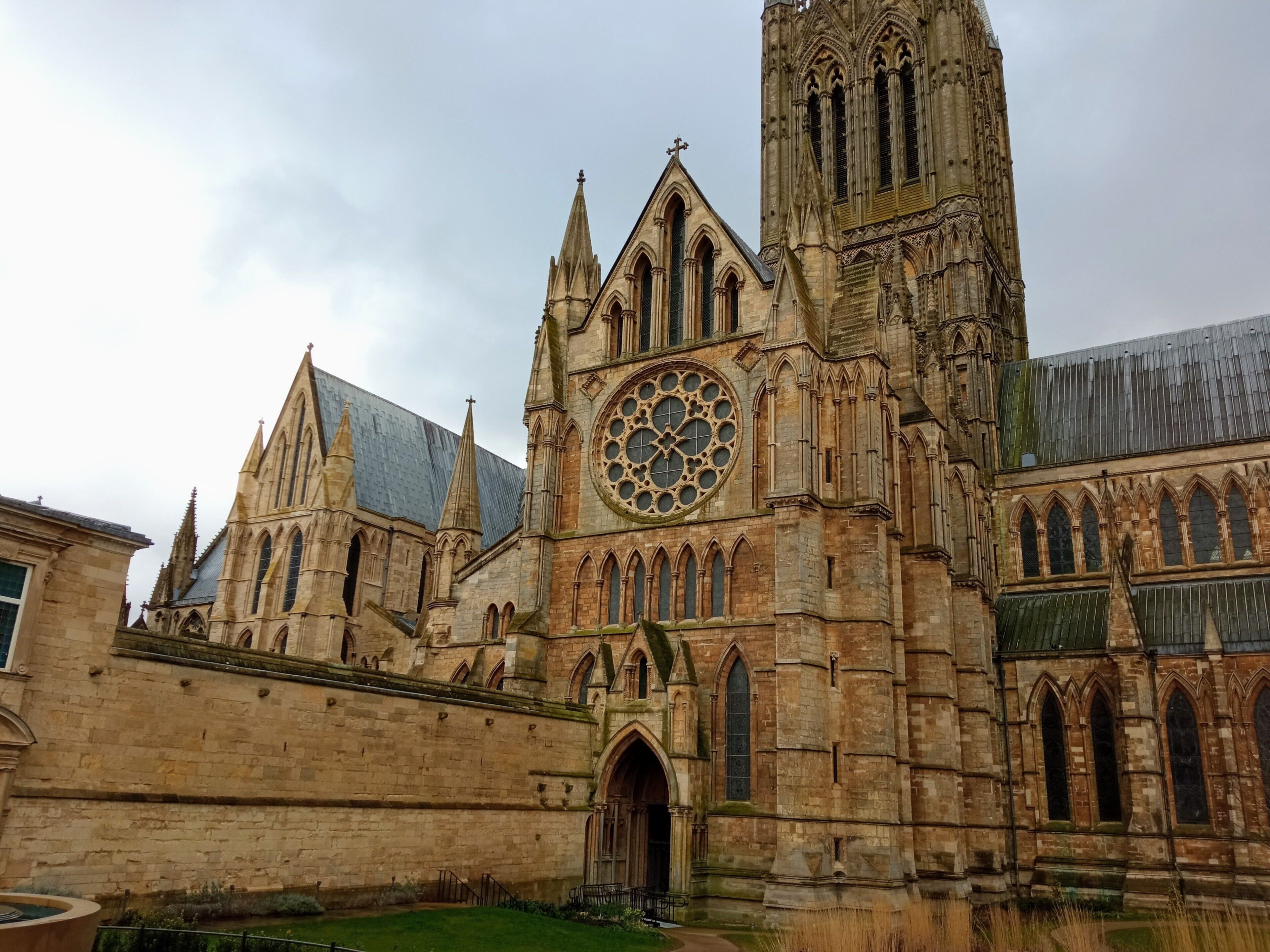 Une église historique dotée d’une grande fenêtre circulaire, d’arcs en ogive et d’un clocher imposant.