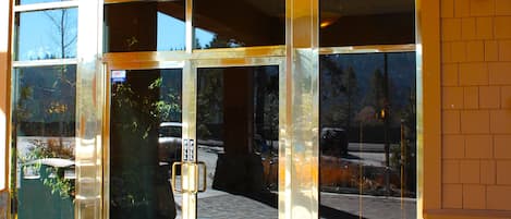 A building entrance with a glass door and a metal handle.