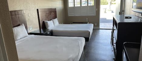 Room, 2 Queen Beds | Bathroom | Combined shower/tub, free toiletries, hair dryer, towels