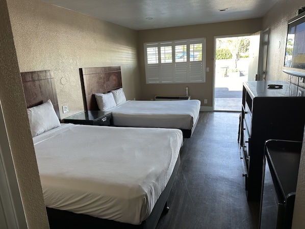 Room, 2 Queen Beds | Bathroom | Combined shower/tub, free toiletries, hair dryer, towels