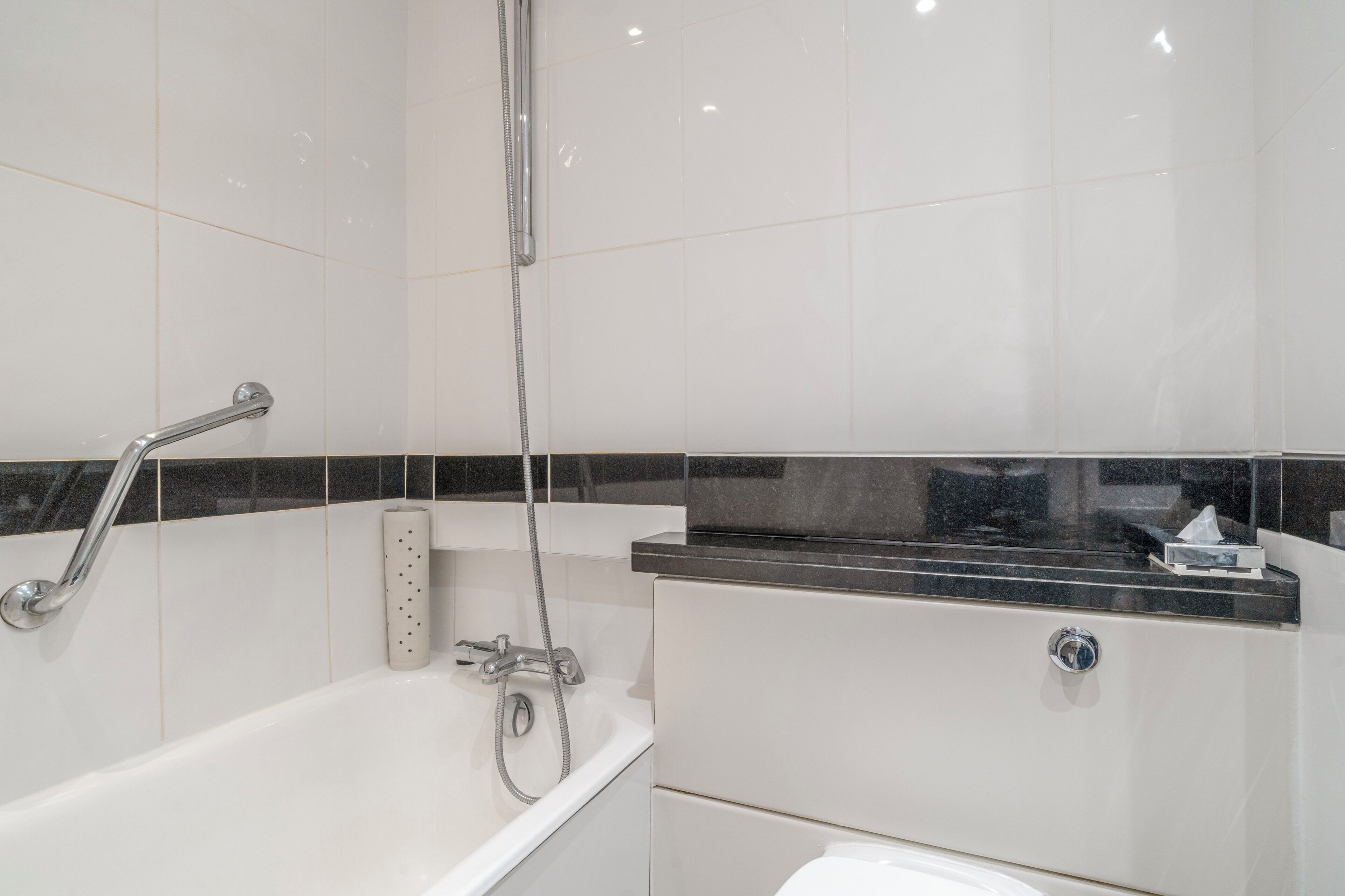 A bathroom with a bathtub, a shower, and a toilet.