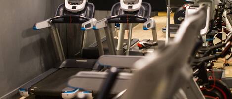 A gym with treadmills and exercise equipment.