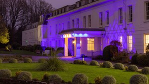 A historic building with a well-maintained garden and a welcoming entrance. - Avisford Park Hotel (Arundel)