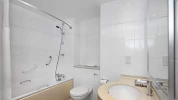 A modern bathroom with a bathtub, toilet, and sink.