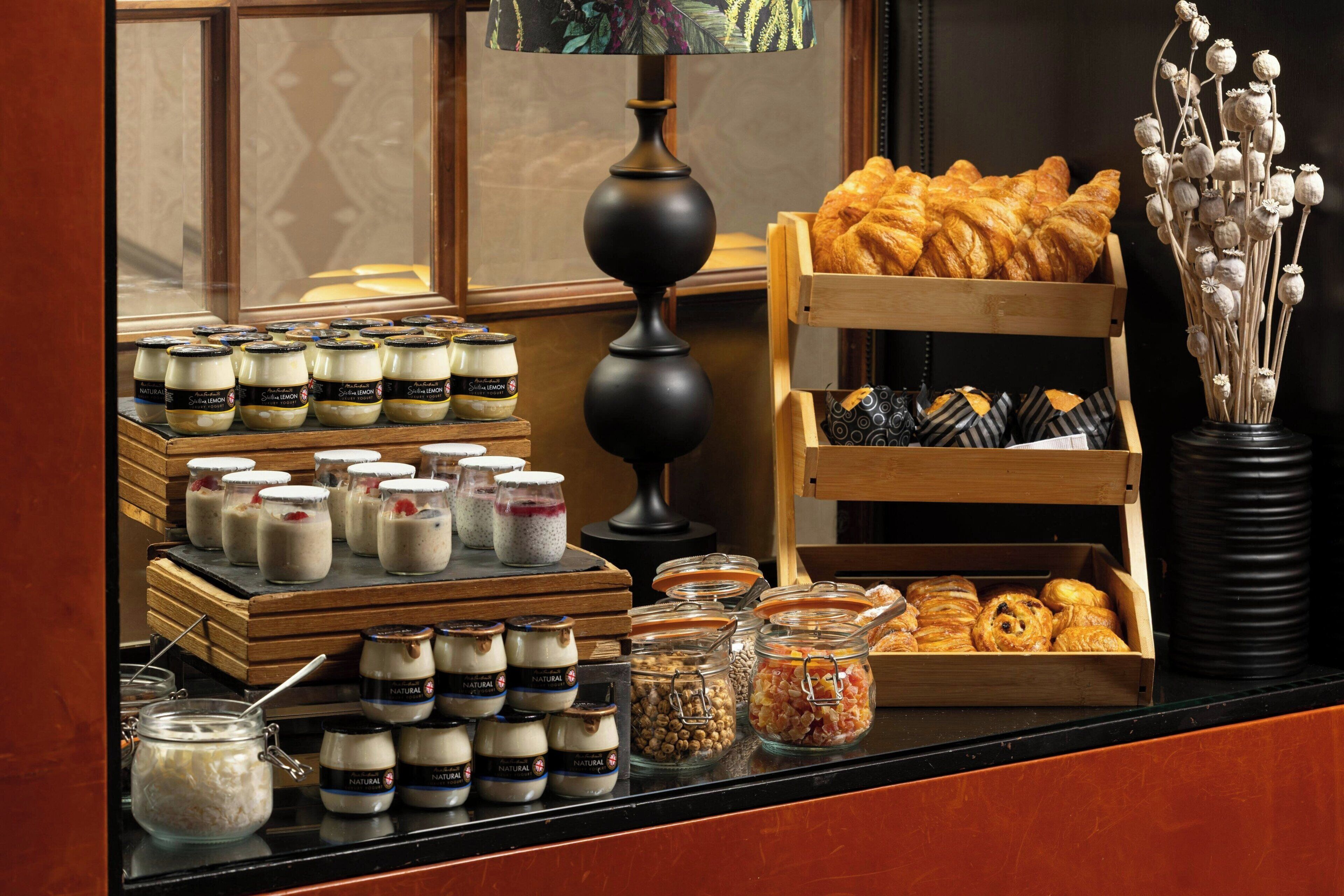 A breakfast buffet with various food items and condiments.