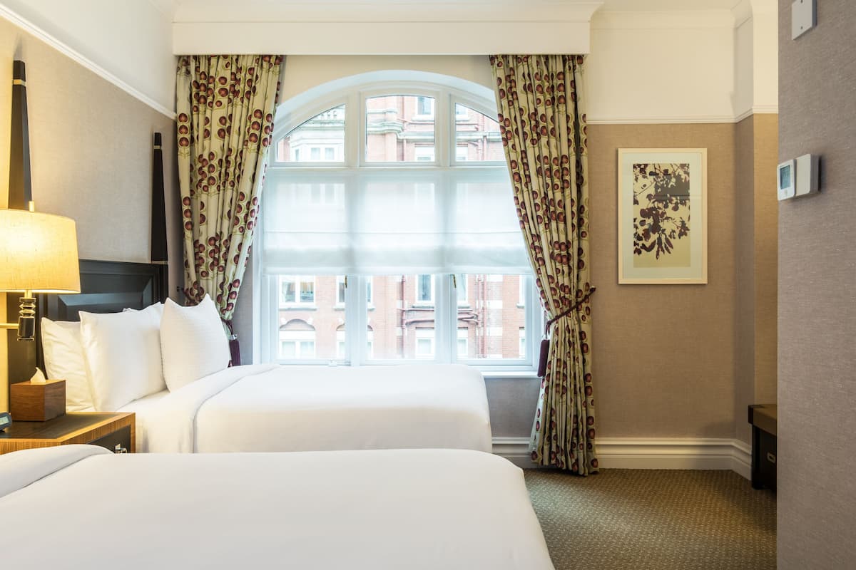 deluxe room, 2 double beds | minibar, in-room safe, desk, iron/ironing board