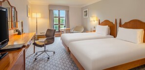 A hotel room with two beds, a desk with a laptop, a chair, a TV, and a window with curtains. - Hilton Puckrup Hall Hotel & Golf Club, Tewkesbury (Tewkesbury)