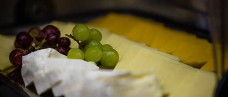A cheese platter with grapes and a banana.