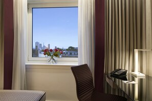 Enjoy a city view from the comfort of your room, with a chair by the window and a desk for work.