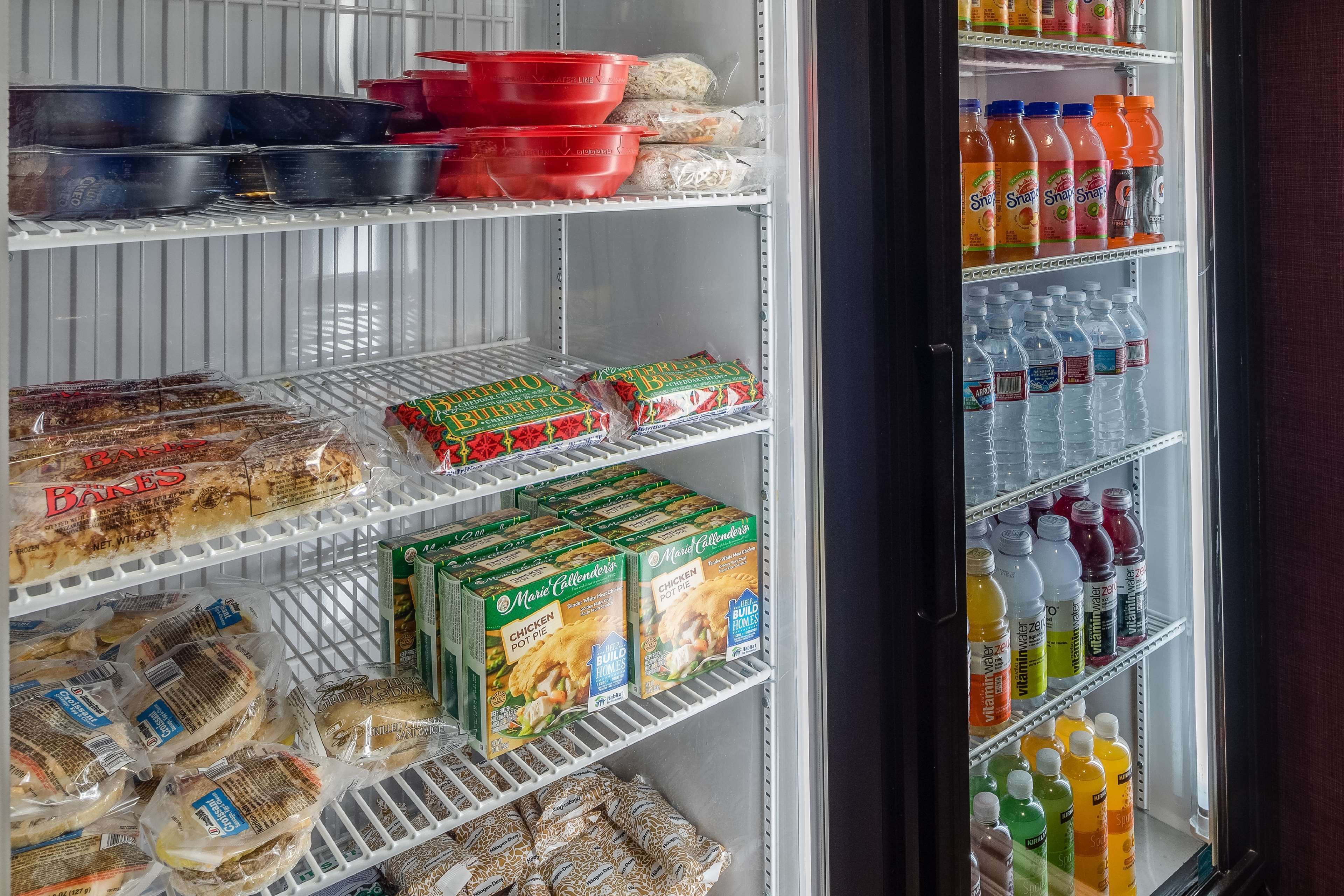 A refrigerated display case with various food items and beverages.