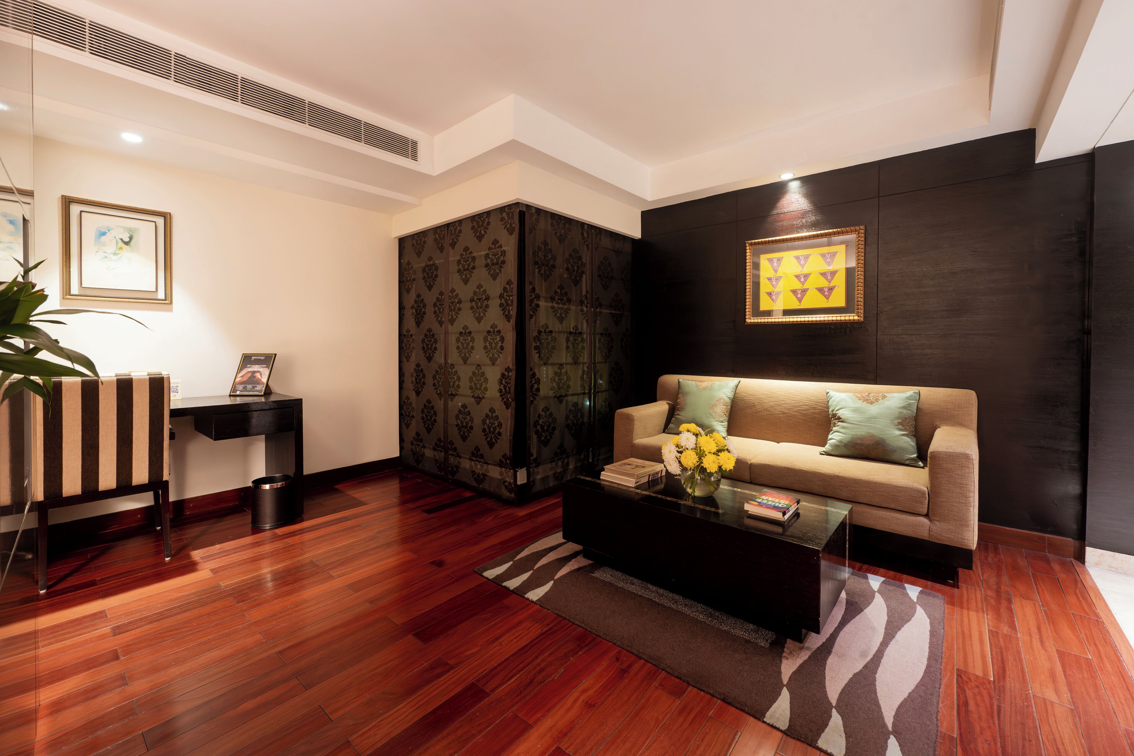 A modern living room with a sofa, coffee table, and decorative items.