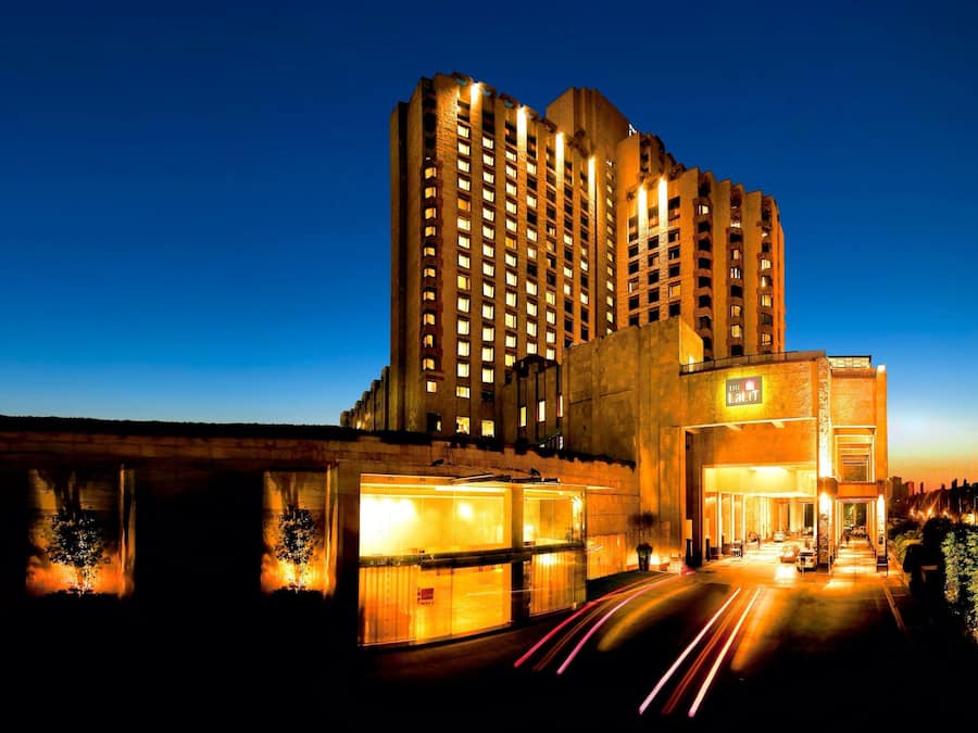 A high-rise hotel with multiple floors and a well-lit entrance.