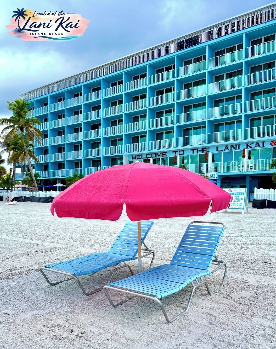A blue building with balconies and a sign that reads "Welcome to the Lani Kai Island Resort."