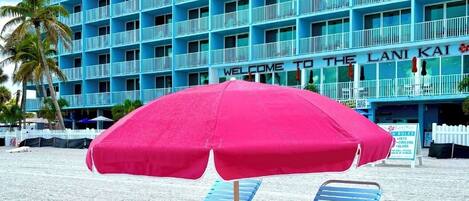 A blue building with balconies and a sign that reads "Welcome to the Lani Kai Island Resort."